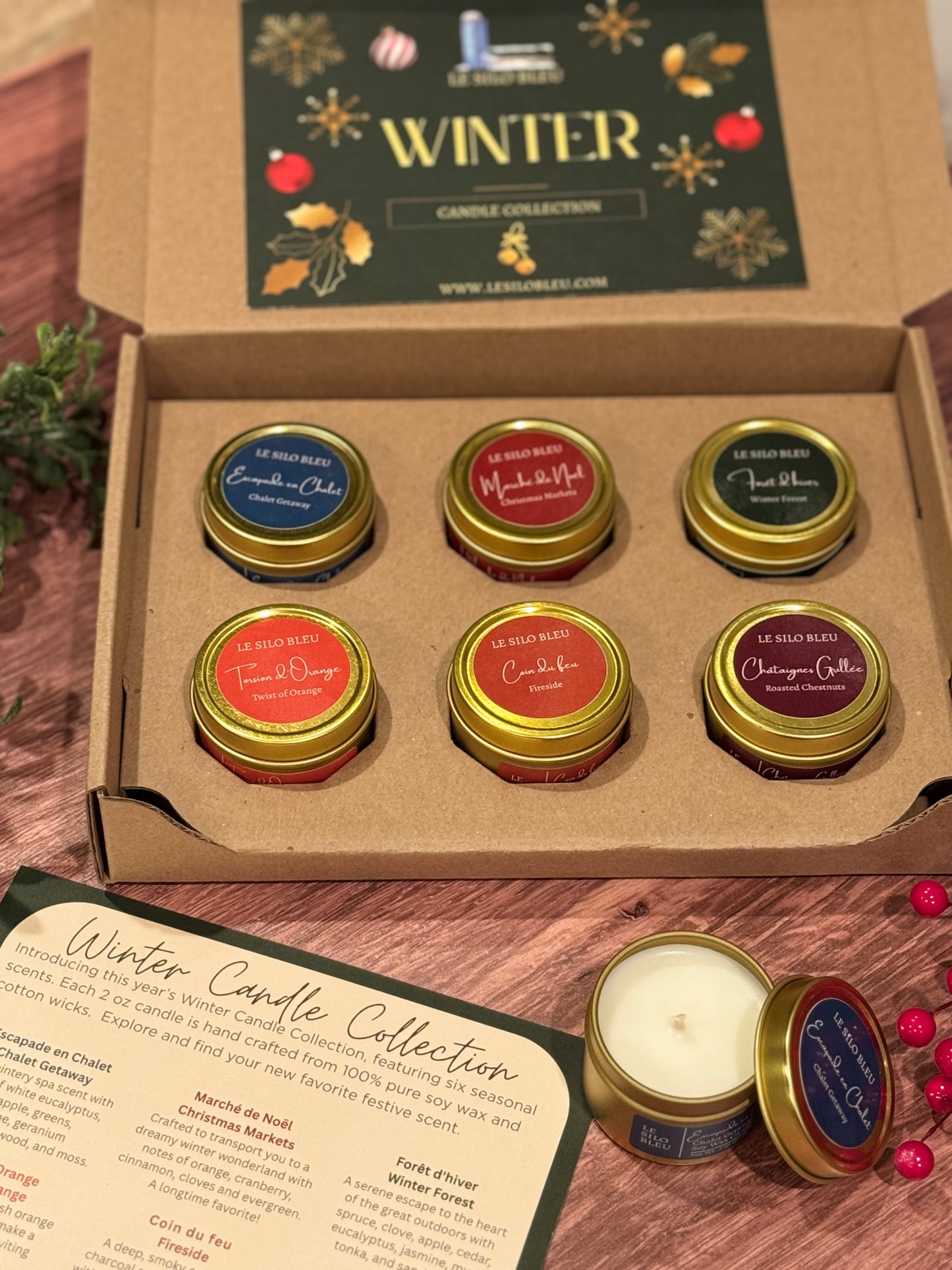 Set of six small candles in a 'Winter' themed box with decorative elements.