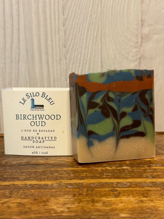 Bar of soap with a colorful pattern on a wooden surface