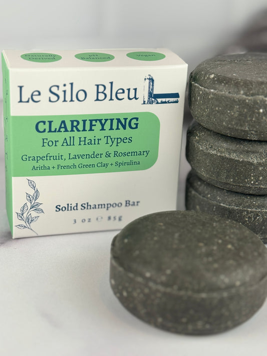 Le Silo Bleu clarifying solid shampoo bars on a white background with the box next to them.